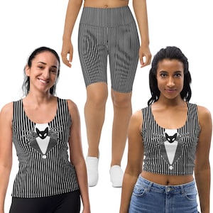 May include: Two women wearing black and white striped clothing with a black cat wearing a bow tie graphic. One woman is wearing a tank top and the other is wearing a crop top.