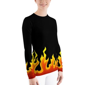 May include: Black long-sleeve shirt with a yellow and orange flame design at the bottom.