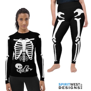 May include: Black long-sleeved shirt with a white skeleton design. The skeleton has a baby skeleton inside the ribcage. A pair of black leggings with a white skeleton design.