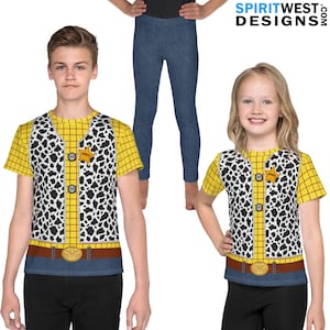 May include: Two children wearing yellow and red plaid shirts with a black and white cow print vest. The shirts have a sheriff's star badge on the front. The children are wearing blue jeans.