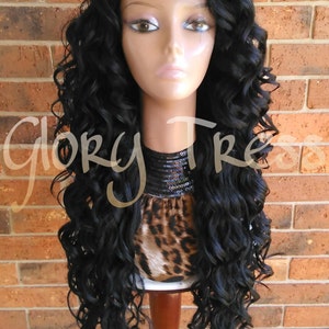 May include: A long, black, curly wig with a lace front. The wig is styled in loose curls and is worn on a mannequin head.