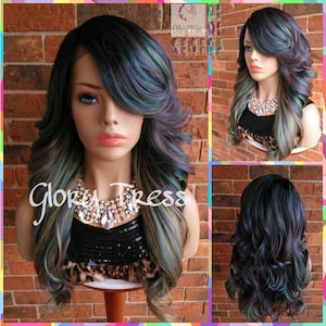 May include: A long, wavy, synthetic wig with black and iridescent green, blue, and purple streaks. The wig has a side part and is styled with loose curls.