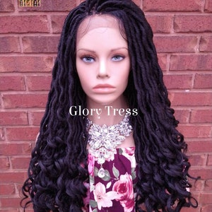 May include: A black lace front wig with long, curly dreadlocks. The wig is styled on a mannequin head and has a natural, realistic look.