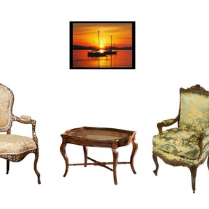 May include: Two antique-style chairs with ornate wood frames and patterned upholstery, one with a beige fabric and the other with a green fabric, are arranged around a wooden coffee table with a glass top. A framed picture of a sunset over the ocean with sailboats is hanging on the wall behind the chairs.