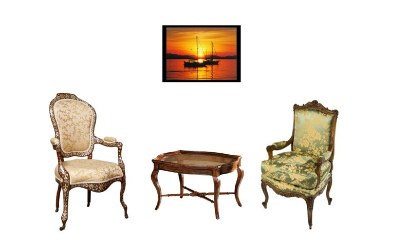 May include: Two antique-style chairs with ornate wood frames and patterned upholstery, one with a beige fabric and the other with a green fabric, are arranged around a wooden coffee table with a glass top. A framed picture of a sunset over the ocean with sailboats is hanging on the wall behind the chairs.