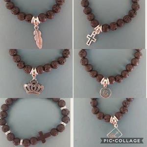 May include: Five lava rock bracelets with different silver charms. The charms include a feather, a cross, a crown, the letter C, and a cross with the words "Holy Bible".