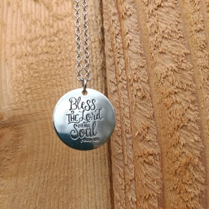 May include: Silver necklace with a round pendant that says "Bless the Lord Oh My Soul Psalm 103".