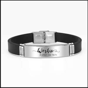 May include: Black silicone bracelet with a silver metal plate that reads "Worship in Spirit and Truth".