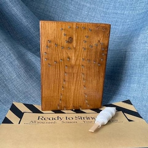May include: Wooden string art kit with nails and white string. The kit includes scissors and instructions. Ready to String: All you need: Scissors, Your yarn, Yourself.