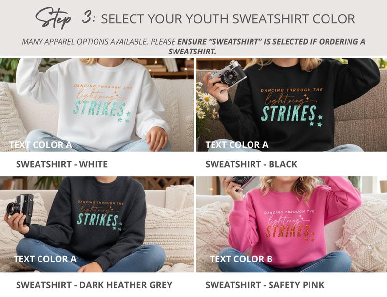 May include: Four youth sweatshirts in white, black, dark heather grey, and safety pink. Each features the text 'DANCING THROUGH THE lightning STRIKES' with star accents. The white, black, and grey shirts have teal text, while the pink has gold text.