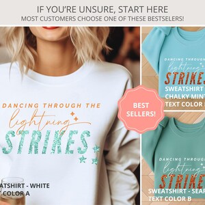May include: A white, chalky mint, and seafoam green crewneck sweatshirt collection featuring the text DANCING THROUGH THE lightning STRIKES with star accents. The designs are displayed in three color variations with specific text color labels.