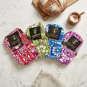 May include: Four colorful sourdough bread bags with tropical patterns, each tied with twine and labeled "Sourdough Tropicale." The bags are red, green, blue, and purple, with a loaf of bread, salt, and a wooden spoon in the background.