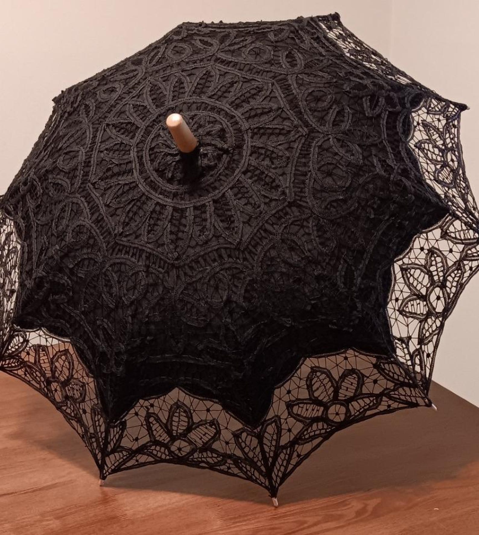 Black gothic lace parasol with floral and mandala-style embroidery, featuring a scalloped edge and wooden handle tip
