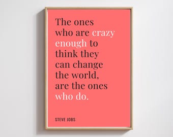 May include: Framed print with a coral background and the quote "The ones who are crazy enough to think they can change the world, are the ones who do." by Steve Jobs. The text is in black and white.
