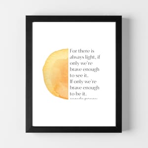 May include: A framed print with a yellow watercolor background and a quote that reads: "For there is always light, if only we're brave enough to see it. If only we're brave enough to be it." The quote is attributed to Amanda Gorman.
