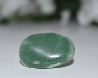 May include: A smooth, green aventurine gemstone, polished to a glossy finish. The stone has a light green color with subtle white inclusions.