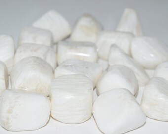 May include: A pile of white tumbled stones, likely made of selenite or white calcite, with a smooth, polished finish.