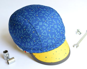 Blue cycling cap with geometric pattern, Spandex cycle hat with yellow brim