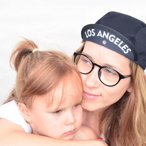 All black cycling cap. Cotton cycle hat with city state name on the brim image 5