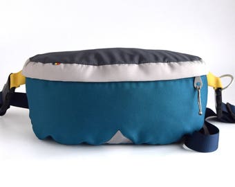 Teal cordura fanny pack with dark gray top and light gray flap. Bum Bag.