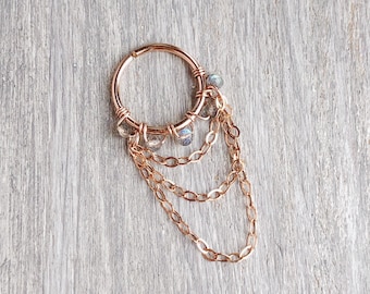 May include: A gold hoop earring with a dangling chain and multiple labradorite beads. The earring is made of rose gold and has a delicate design.