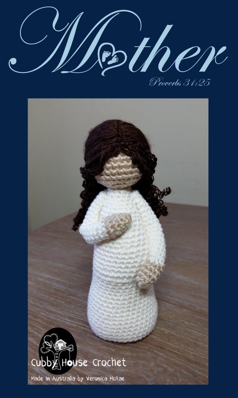 May include: Crocheted doll with brown hair and a white dress. The doll is standing on a wooden surface. The text "Mother" is written in cursive above the doll. The text "Proverbs 31:25" is written below the doll. The text "Cubby House Crochet" is written below the doll. The text "Made in Australia by Veronica McRae" is written below the doll.