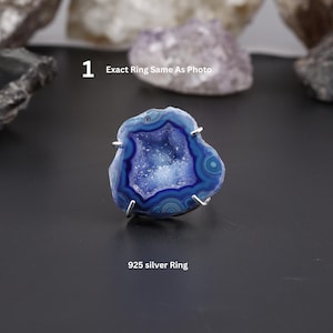 May include: A 925 silver ring featuring a blue and white agate stone. The stone has a geode-like center and is mounted on a silver band. The ring is a unique piece of jewelry.