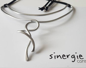 Silver color aluminum sculpture necklace. Bright and very light. Wearable art. Contemporary. Original unique. "Hugs" theme.