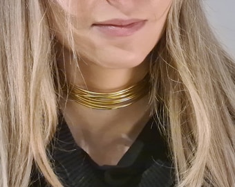 Choker necklace and golden bracelet. Contemporary jewelry. Rock chic style.