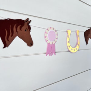 pony garland with ponies, gold foil horseshoes and pink ribbons