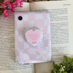 May include: A set of three ceramic mugs with a speckled, matte finish in cream, light grey, and dark grey. Each mug has a simple, minimalist design and a rounded handle.