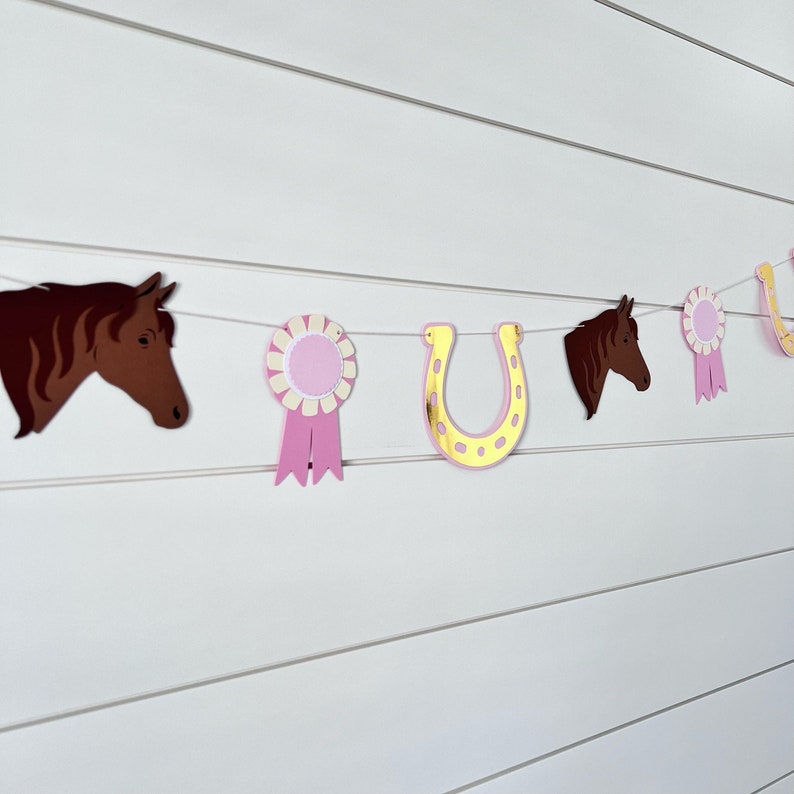 pony garland with ponies, gold foil horseshoes and pink ribbons