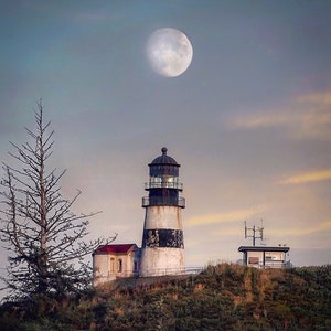 May include: A black and white striped lighthouse with a white roof stands on a grassy hill with a full moon in the sky. The lighthouse has a small building next to it.
