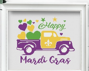 May include: A cross-stitch pattern featuring a purple truck with a yellow cab, carrying green and yellow hearts. The truck has a fleur-de-lis on the side. The text "Happy Mardi Gras" is written in purple below the truck.