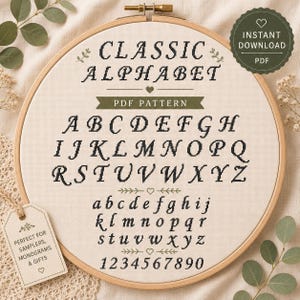 May include: A cross stitch pattern displayed in a wooden embroidery hoop on cream fabric. The text reads CLASSIC ALPHABET, PDF PATTERN, and includes uppercase letters A-Z, lowercase letters a-z, and numbers 0-9 in a black stitched font style.