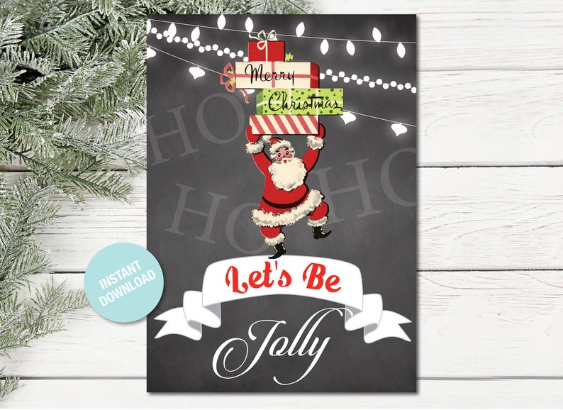 May include: A black chalkboard with white string lights and a cartoon Santa Claus holding a stack of presents that say "Merry Christmas". The text "Let's Be Jolly" is written in white on a white banner.