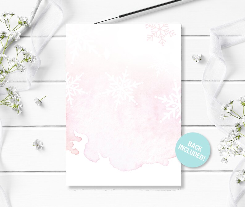May include: A blank white card with a watercolor background in shades of pink and blue. The card is decorated with white snowflake designs. The text "Back Included!" is printed on a blue circle sticker in the bottom right corner.