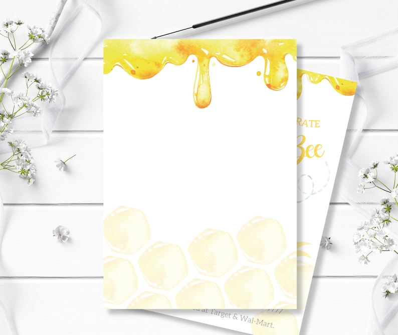 May include: A white card with a yellow honeycomb pattern and dripping honey design. The text "Celebrate Bee" is printed on the card.