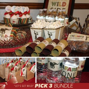 May include: A jungle-themed party table setting with brown and green paper goods, including napkins, favor bags, and water bottle labels. The table also features popcorn in brown paper cups, chocolate treats in a brown paper bag, and cupcakes with jungle animal toppers. The text "Let's Get Wild" and "Pick 3 Bundle" are visible on the table.
