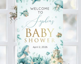 May include: A blue and white welcome sign for a baby shower with the text "Welcome to Sophia's Baby Shower" and the date "April 2, 2026". The sign features a whale, a castle, starfish, and other ocean-themed illustrations.