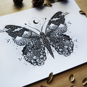 May include: Black and white ink drawing of a butterfly with a mountain range and starry sky inside the wings. The butterfly is surrounded by a floral design.