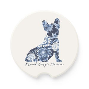 May include: White ceramic coaster with a blue floral design of a French Bulldog silhouette. The text "Proud Corgi Mama" is written below the dog.