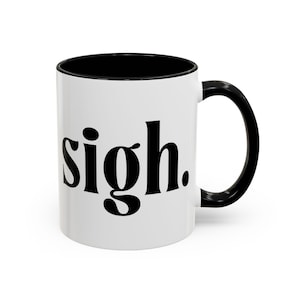 May include: White ceramic coffee mug with a black rim and handle. The mug has the word "sigh." printed in black on the front.