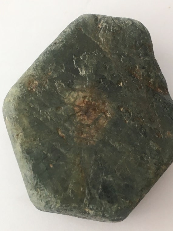 Rough green sapphire - holdingsose