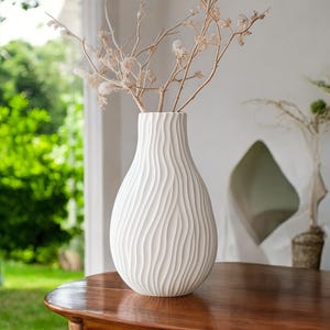 May include: A set of three ceramic mugs with a speckled, matte finish. The mugs are in shades of cream, light brown, and dark brown. Each mug has a simple, minimalist design, perfect for coffee or tea.