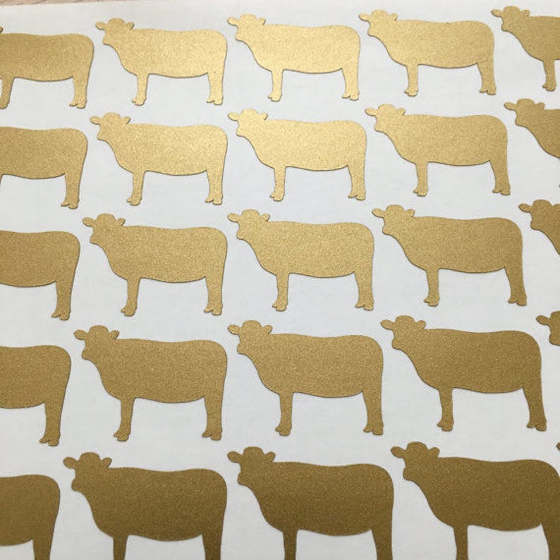 May include: A sheet of gold glitter cow stickers. The stickers are all the same size and shape, and they are arranged in a grid pattern.