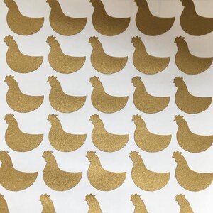 May include: A sheet of gold glitter chicken stickers. The stickers are about 2 inches tall and 1.5 inches wide.
