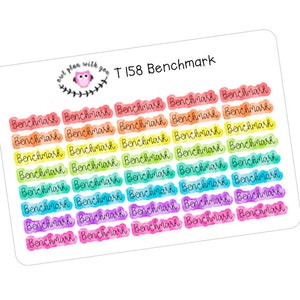 May include: A sheet of colorful stickers with the text "Benchmark" repeated 25 times. The stickers are in a rainbow gradient of colors, starting with red and ending with purple. The text "T 158 Benchmark" is printed at the top of the sheet.