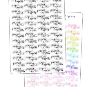 May include: A sheet of stickers with the text "Progress Reports" in a variety of colors, including pink, purple, blue, green, yellow, and orange. The stickers are arranged in rows and columns.