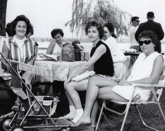 By mid-afternoon, the moms were happy to let the kids run amok. 1960s  snapshot of women sitting around a picnic table with a stroller.
